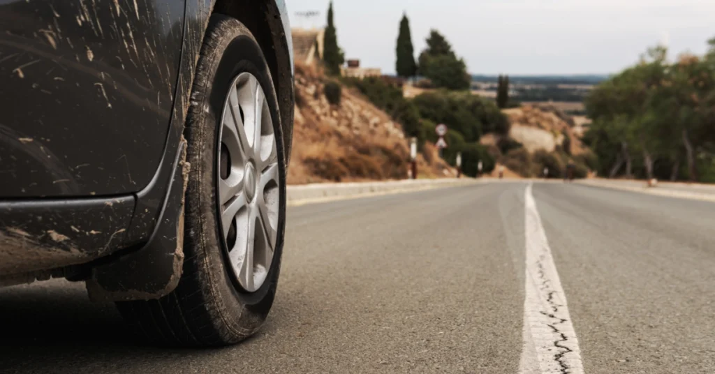 Car tyre on a road representing HMRC mileage claims for business travel